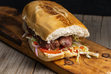 choripan chorizo sandwich on bread with vegetables and chimichurri
