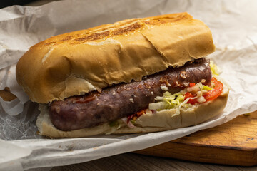 choripan chorizo sandwich on bread with vegetables and chimichurri