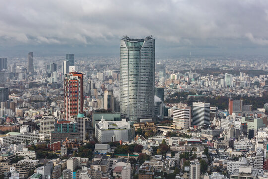 TOKYO, JAPAN - NOVEMBER 26, 2015: View from above  of Mori Buildind and the surrounding skyscrapers and high - rise buildings in Minato City, Tokyo on a cloudy background.