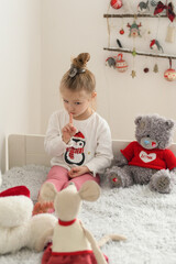 Girl playing in a room with plush toys