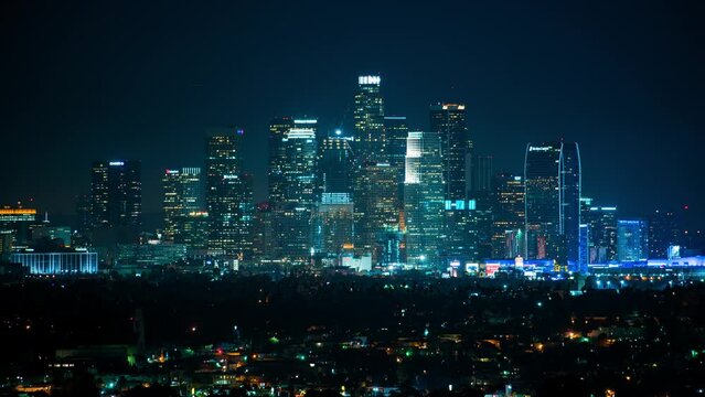 Aerial Lockdown Shot Of Illuminated Skyscrapers Against Clear Sky In City At Night - Los Angeles, California