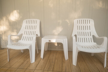 Nobody white chair around outdoor swimming pool in resort hotel empty behind the room for leisure travel vacation