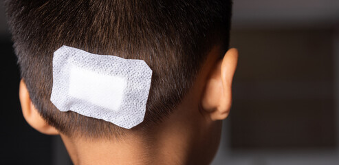 The lacerated suture wound of kid back head which suture with trauma the head by medical bandage,...