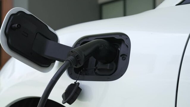 Home charging station providing sustainable, renewable source of power for electronic vehicle, EV cars at home for progressive modern lifestyle. Eco-friendly hybrid electro and petrol vehicle battery.