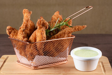 pieces of fried fish breaded with panko flour served with herb sauce, cod