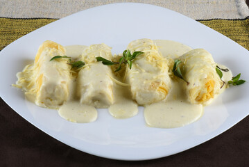 rondelli and cannelloni pasta in white sauce with parmesan cheese