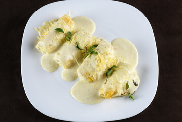 rondelli and cannelloni pasta in white sauce with parmesan cheese