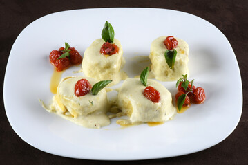 rondelli and cannelloni pasta in white sauce with parmesan cheese