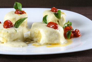 rondelli and cannelloni pasta in white sauce with parmesan cheese