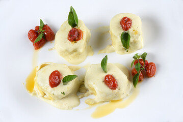 rondelli and cannelloni pasta in white sauce with parmesan cheese