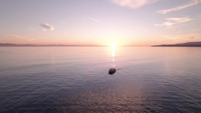 Fishing boat at sunset, aerial drone footage boat in harbour at sunset, Sooke BC, sunset sky. 4K 24FPS.