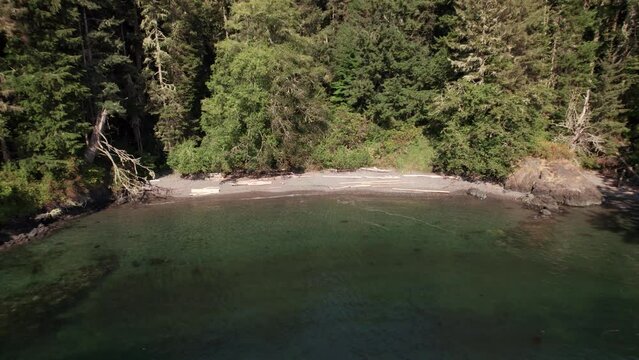 A aerial drone shot of the beautiful coastline, ocean, West Coast Canada, with turquoise water near Sooke, BC. 4K 24FPS.