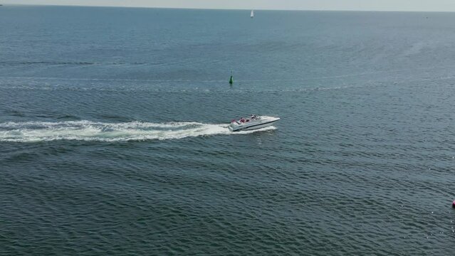 Drone view of the white boat driving in the water, Fehmarn island, Germany