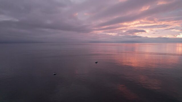 Fishing boat at sunset, aerial drone footage boat in harbour at sunset, Sooke BC, sunset sky. 4K PRORES 422 24FPS.