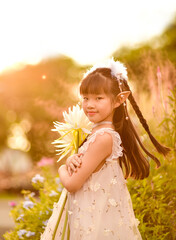 beautiful little girl in elf or fairy dress holding Epiphyllum flower, backlight Photography