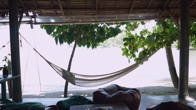 Couple conversating sitting on couch outdoors and drinking coconut water - slow motion 