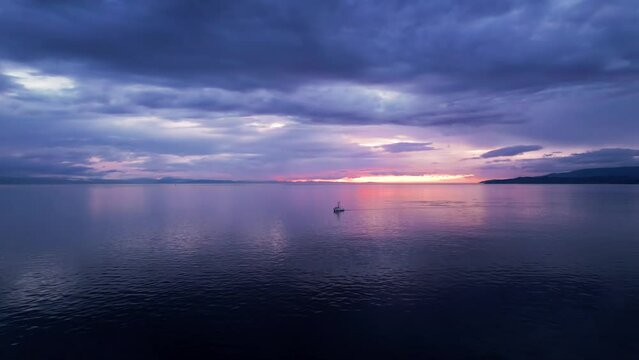 Fishing boat at sunset, aerial drone footage boat in harbour at sunset, Sooke BC, sunset sky. 4K PRORES 422 24FPS.
