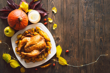 Happy Thanksgiving. Autumn composition with leaves, ripe pumpkin and Thanksgiving turkey on a dark...