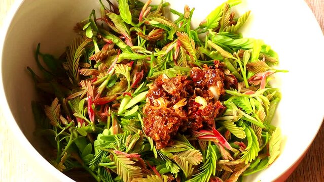 Young tamarind leaves with ingredients to make salad, Thai northern famous food.