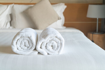 white towel on bed in bedroom