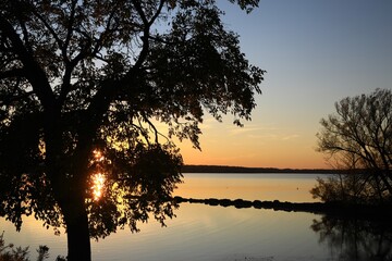 Fototapeta na wymiar Sunset sky near a small rural lake 