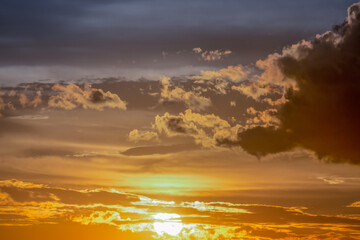 Naklejka na ściany i meble Sunrise dramatic sky with clouds in a row, colorful cloudscape