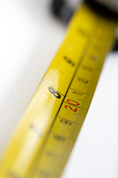 Yellow tape measure showing 8 inches and 20 centimeters