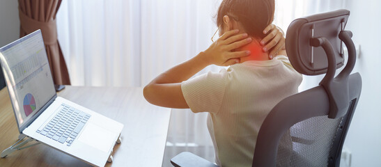 Woman having Neck and Shoulder pain during work long time on workplace. due to fibromyalgia,...