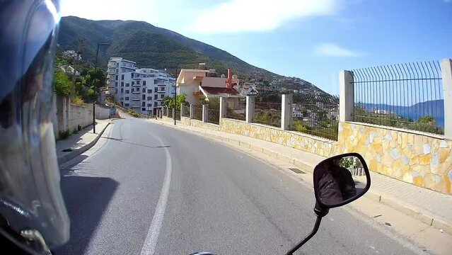 riding mountains coast on motorcycle pov, sun beams, beautiful landscape, amateur travel video