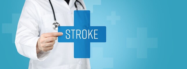 Stroke. Doctor holding blue cross with medical term on it.