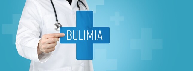 Bulimia nervosa. Doctor holding blue cross with medical term on it. - obrazy, fototapety, plakaty