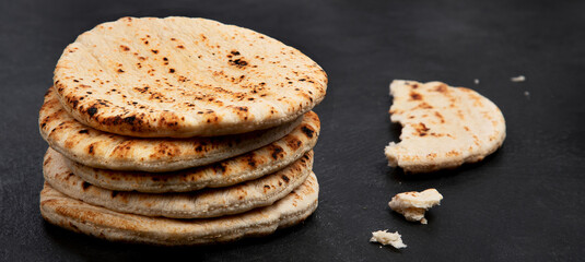 .Pita bread on dark background. Arabic, lebanese bread, traditional food.