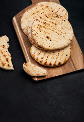 .Pita bread on dark background. Arabic, lebanese bread, traditional food.