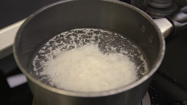 Pouring maize flour in boiling water for Ugali porridge preparation