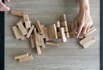 Wooden blocks from tower constructed game fall scattered all over the table. Top view
