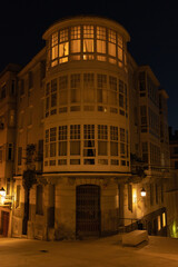 Light in the window of the building of the night city, large windows modern design of the house.