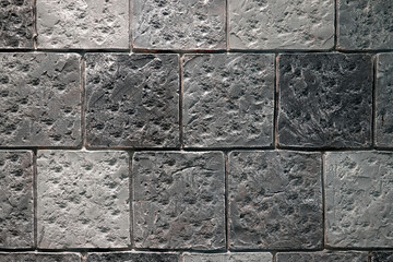 Square light gray brick wall.  masonry gray rough texture. 