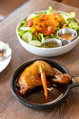 Roasted chicken with Japanese salad on wooden brown table and background.