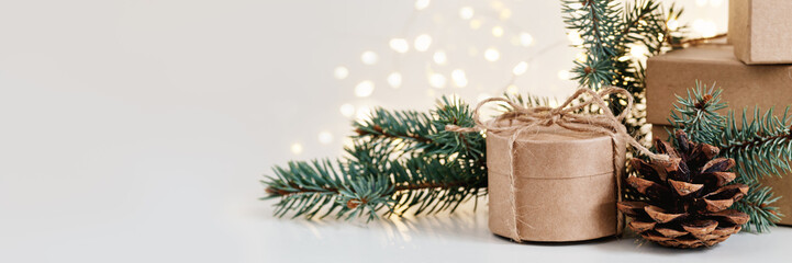 Christmas gift boxes with natural decor on shining bokeh banner. Christmas zero waste, boxing day and winter holiday