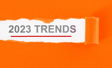 Torn orange color paper with space writing 2023 trends