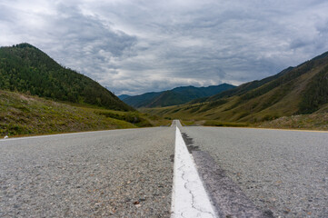 A road surrounded by mountains in the Altai Republic. Gorny Altai