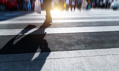 People walking on the crosswalk at busy street