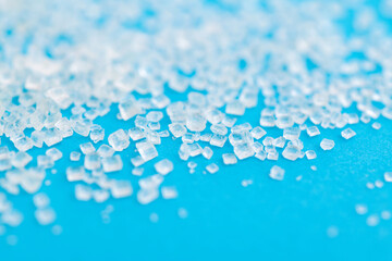 White sugar crystals on blue background
