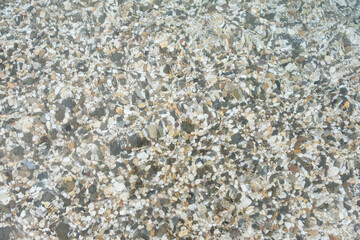 Pebbles on the beach. Beach with colorful rocks. Pebble by the sea. Pebbles under water background. Black sea. 