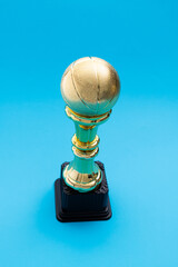 Golden basketball trophy on blue background
