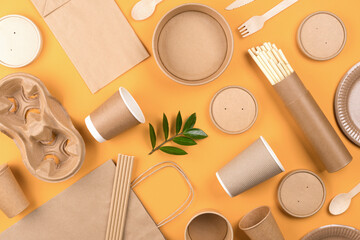 Eco-friendly tableware - kraft paper food packaging over orange background. Street food paper...