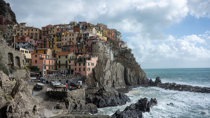 Fototapeta na wymiar Manarola, Italy during a summer rain. Manarola is built on a high rock 70 metres above sea level, is one of the most charming and romantic of the Cinque Terre villages.