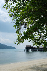 Beautiful sea overlooking the stilt house at Pangkor Laut with lush of greenery and southeast asia style of architecture.