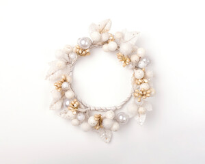 White decorative wreath on a white background. Holiday decoration, Christmas decoration. Image with place for text.