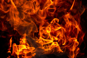 Burning fire close up. Bright orange and red flames on a dark background. Open flame heating. Problems with heating and gas.